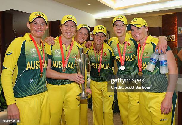 Erin Osborne, Alex Blackwell, Alyssa Healy, Julie Hunter, Ellyse Perry and Jess Cameron of Australia pose with the trophy in the changing rooms after...