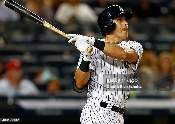 Jacoby Ellsbury of the New York Yankees hits a home run in the seventh inning against the Boston Red Sox during a MLB baseball game at Yankee Stadium...