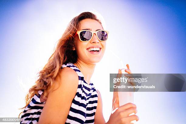 cheerful girl having a cool drink - blue sunglasses stock pictures, royalty-free photos & images