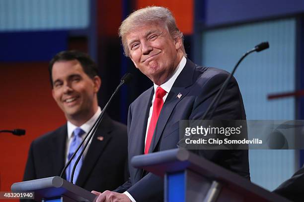 Republican presidential candidates Donald Trump and Wisconsin Gov. Scott Walker participate in the first prime-time presidential debate hosted by FOX...