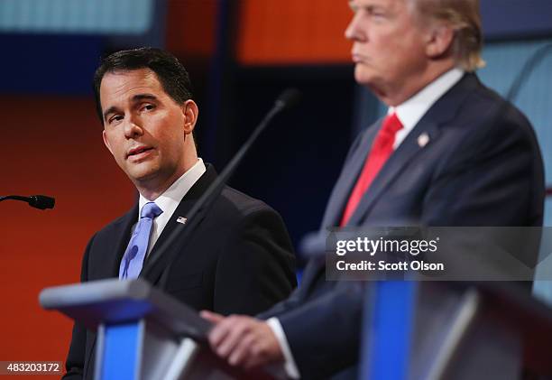 Republican presidential candidate Wisconsin Gov. Scott Walker listens as Donald Trump fields a question during the first Republican presidential...