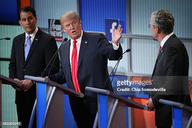 Republican presidential candidates Wisconsin Gov. Scott Walker, Donald Trump and Jeb Bush participate in the first prime-time presidential debate...