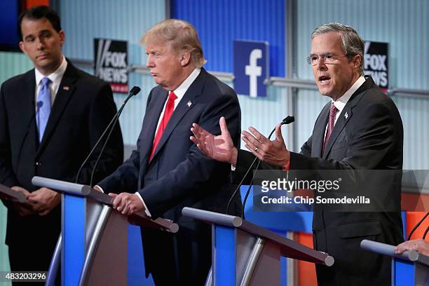 Republican presidential candidates Wisconsin Gov. Scott Walker, Donald Trump and Jeb Bush participate in the first prime-time presidential debate...