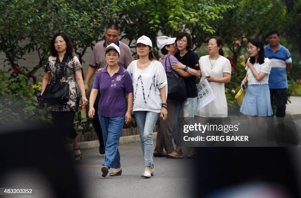 Relatives of passengers on missing Malaysia Airlines MH370 walk out from an office where they were expecting a meeting with Malaysian officials, on...