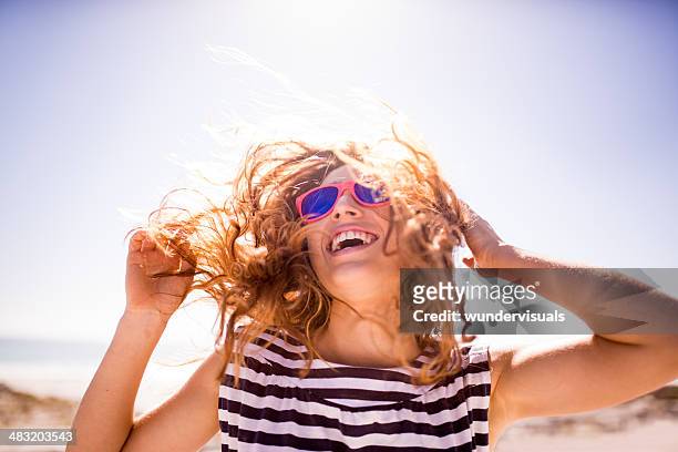 cheerful laughing woman on the beach - sunlight stockfoto's en -beelden