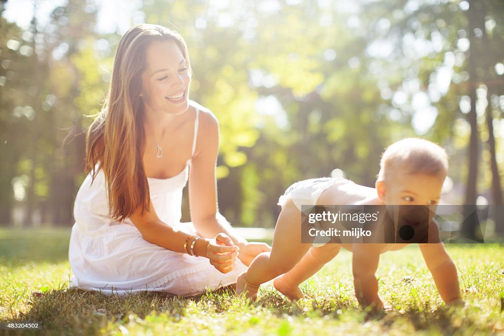 Young mother enjoying in nature with her son