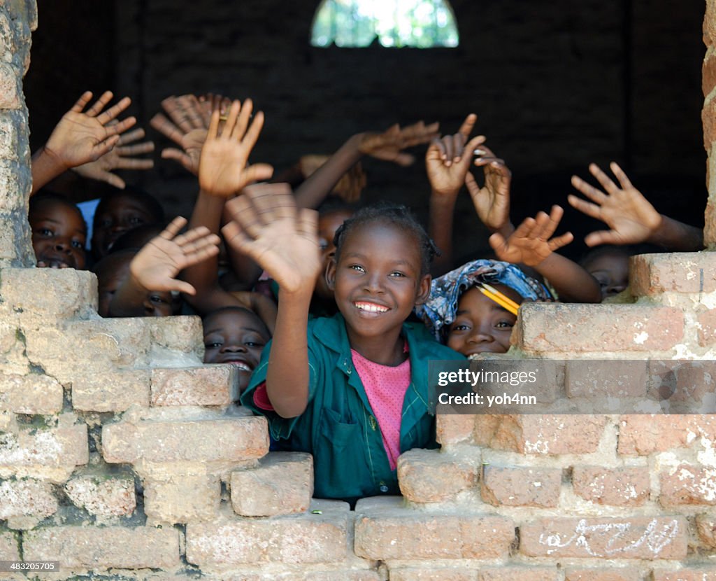 Several African children waving hands in Tchad