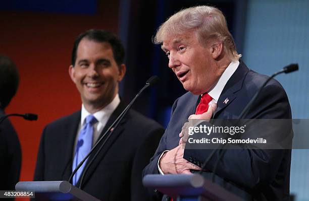 Republican presidential candidates Donald Trump and Wisconsin Gov. Scott Walker participate in the first prime-time presidential debate hosted by FOX...