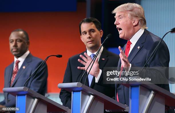 Republican presidential candidates Ben Carson, Wisconsin Gov. Scott Walker and Donald Trump participate in the first prime-time presidential debate...