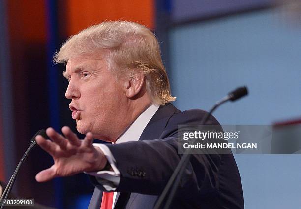 Real estate tycoon Donald Trump speaks during the prime time Republican presidential debate on August 6, 2015 at the Quicken Loans Arena in...