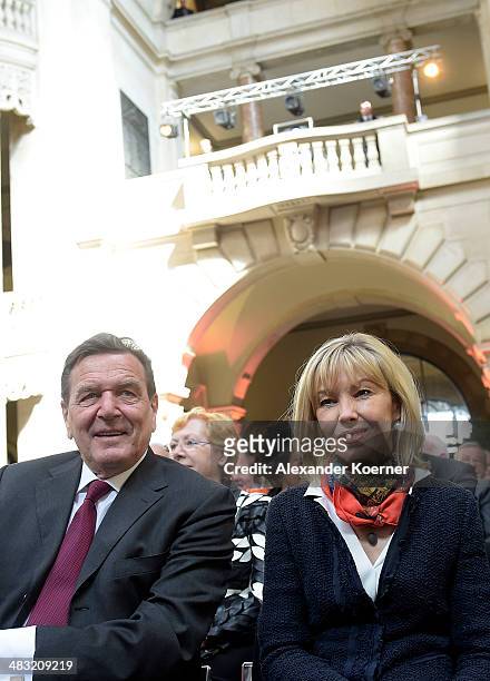 Former German Chancellor Gerhard Schroeder and his wife Doris Schroeder-Koepf attend a reception to celebrate his 70th birthday at City Hall on April...