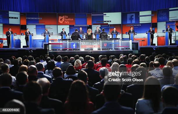 Guests watch Republican presidential candidates speak during the first Republican presidential debate hosted by Fox News and Facebook at the Quicken...
