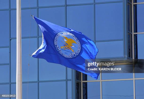 This 06 April, 2005 photo shows the flag of the National Rifle Association flying in front of the institution's headquarters in Fairfax, Virginia....