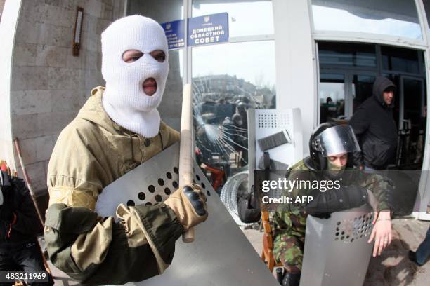 Pro-Russian activists guard the main administration building in the eastern Ukrainian city of Donetsk on April 7 in Donetsk. They proclaimed on April...