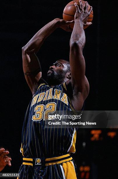 Dale Davis of the Indiana Pacers puts up a shot in the game against the Charlotte Hornets on April 9, 2000 at Charlotte Colesium in Charlotte, North...