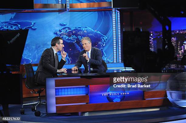 John Oliver and host Jon Stewart appear on "The Daily Show with Jon Stewart" #JonVoyage on August 6, 2015 in New York City.
