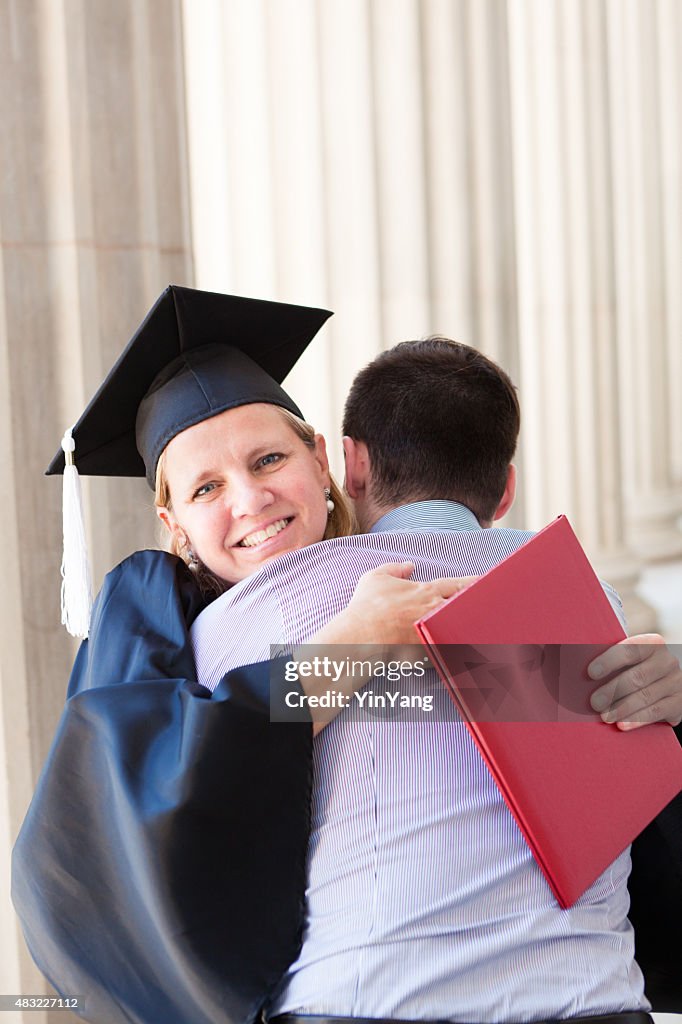 Middle Aged Woman Graduation in Higher Degree Hugging Family