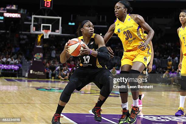 Karima Christmas of the Tulsa Shock handles the ball against Nneka Ogwumike of the Los Angeles Sparks in a WNBA game at Staples Center on August 6,...