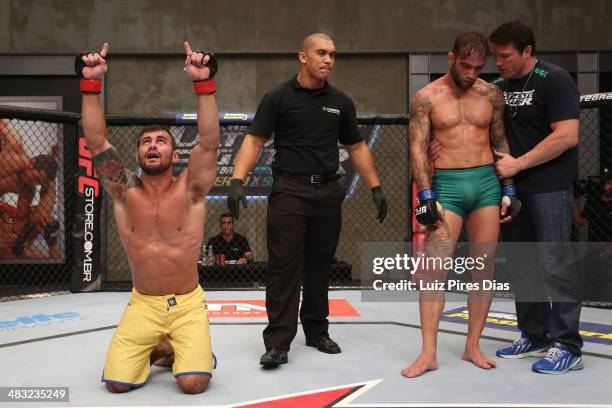 Team Wanderlei fighter Ricardo Abreu celebrates after defeating Team Sonnen fighter Guilherme de Vasconcelos as coach Chael Sonnen consoles...