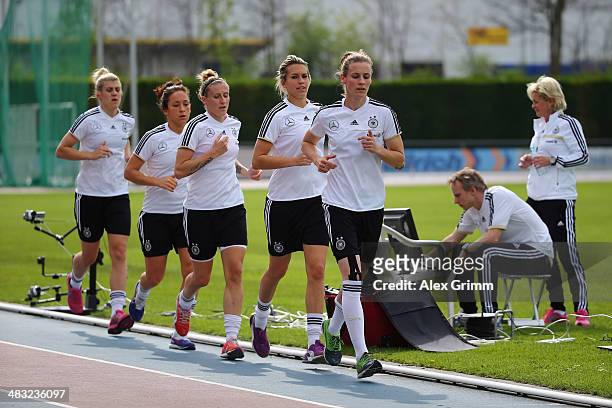 Head coach Silvia Neid watches Simone Laudehr, Lena Goessling, Anja Mittag, Nadine Kessler and Luisa Wensing run during a Germany women's national...