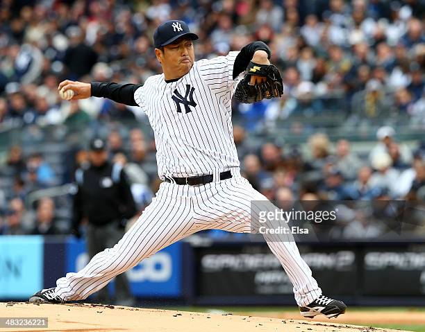 Hiroki Kuroda of the New York Yankees delivers a pitch in the first inning against the Baltimore Orioles during the home opener on April 7, 2014 at...