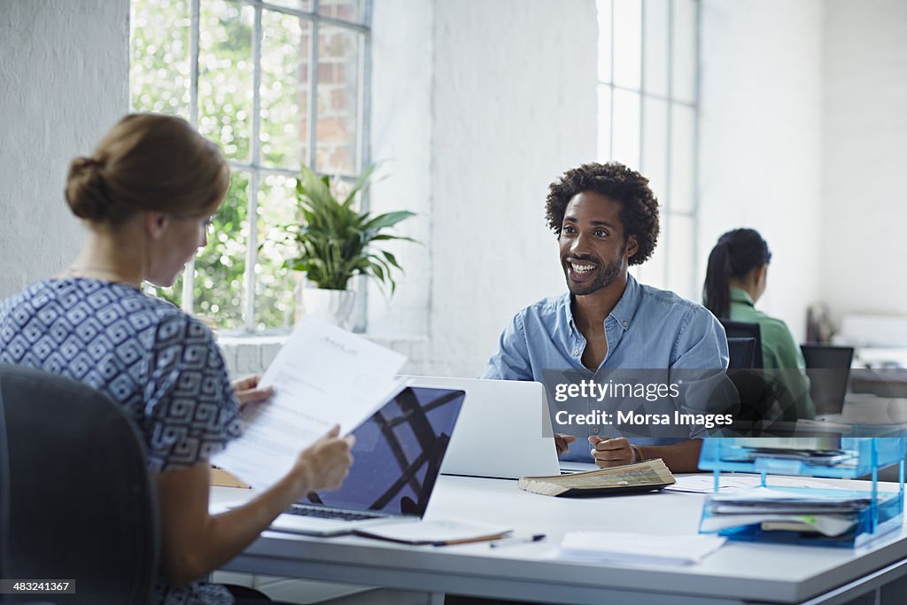 Work colleagues going through papers