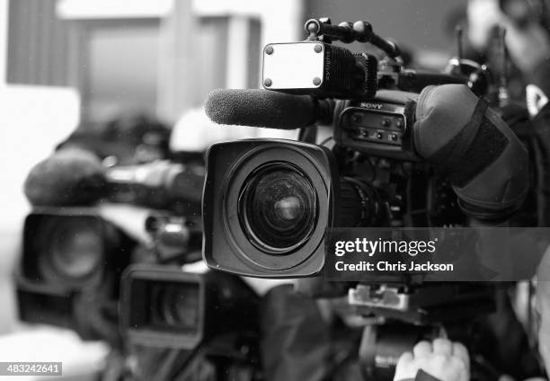 Cameras focus onto the tarmac in the rain ahead of the arrival of Catherine, Duchess of Cambridge, Prince William, Duke of Cambridge and Prince...