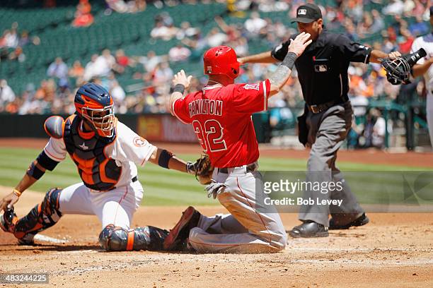 Josh Hamilton of the Los Angeles Angels of Anaheim scores in the first inning as Carlos Corporan of the Houston Astros is late on the tag at Minute...