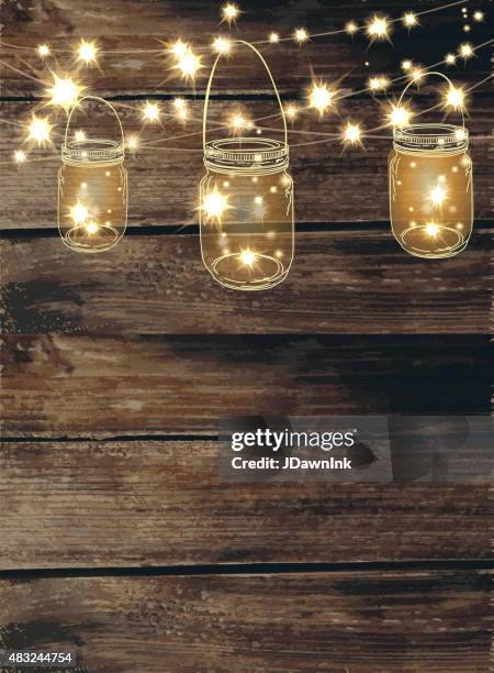 wooden background with jar and string lights - wedding invitation stock illustrations