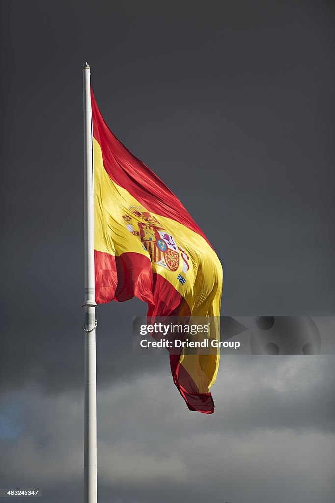 Spanish flag and winter clouds.