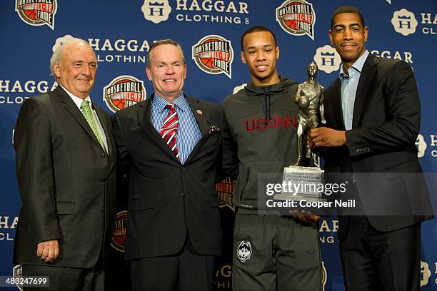 Ken Kaufman, John L. Doleva, Shabazz Napier and Kevin Ollie pose for a photo as Napier recieves he Bob Cousy Award at the Omni Hotel on April 7, 2014...