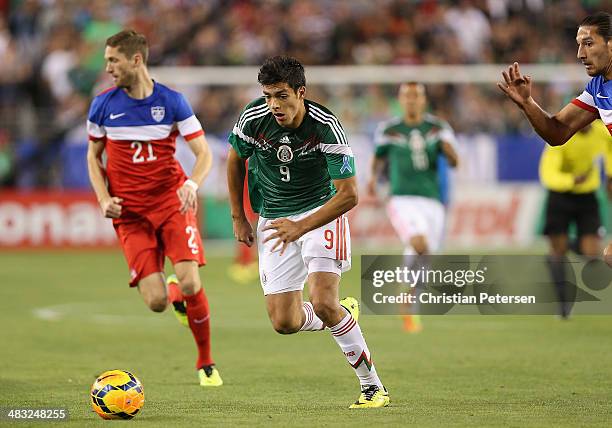 Raul Jimenez of Mexico controls the ball past Clarence Goodson of USA during the International Friendly at University of Phoenix Stadium on April 2,...