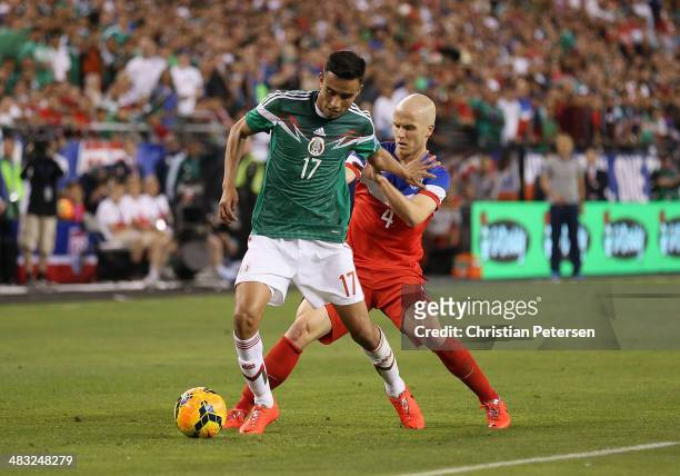 Jesus Eduardo Zavala of Mexico controls the ball past Michael Bradley#4 of USA during the International Friendly at University of Phoenix Stadium on...