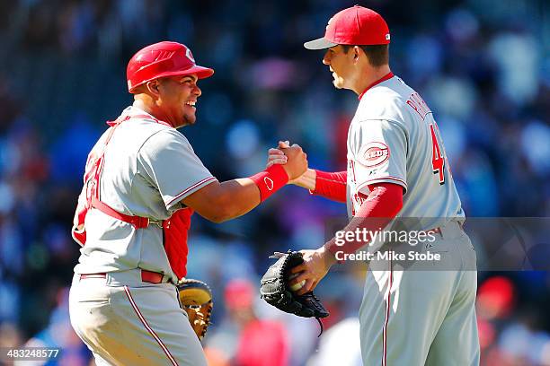 Brayan Pena of the Cincinnati Reds and teamate Manny Parra celebrate after defeating the New York Mets at Citi Field on April 6, 2014 in New York...