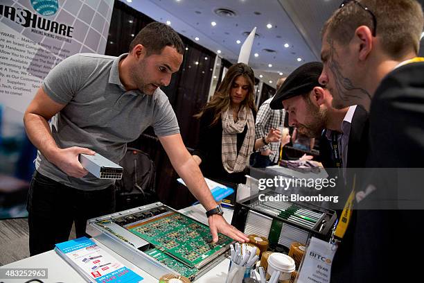 An exhibitor, left, demonstrates bitcoin script writers during the Inside Bitcoins conference in New York, U.S., on Monday, April 7, 2014. Inside...