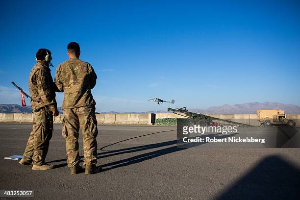 Two U.S. Army soldiers launch a 14' Shadow Unmanned Aerial Vehicle, or UAV, from an airstrip at Forward Operating Base Shank May 8, 2013 in Logar...