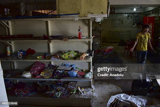 The owner of a grocery store gestures after suffering from looting in San Felix, Venezuela on August 6, 2015. The country has been suffering from...