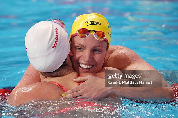 Missy Franklin of the United States hugs Emily Seebohm of Australia after the Women's 200m Backstroke heats on day fourteen of the 16th FINA World...