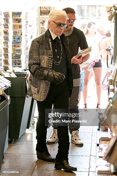 Karl Lagerfeld is seen at the newspaper store on the harbour of Saint tropez on August 6, 2015 in Saint-Tropez, France.