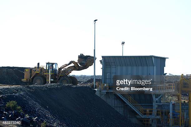 Front loader deposits ore into a shaft at the processing plant at Evolution Mining Ltd.'s gold operations in Mungari, Australia, on Wednesday, Aug....