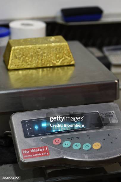 Bar of gold is shown to weigh 1766 grams at Evolution Mining Ltd.'s gold operations in Mungari, Australia, on Wednesday, Aug. 5, 2015. A declining...