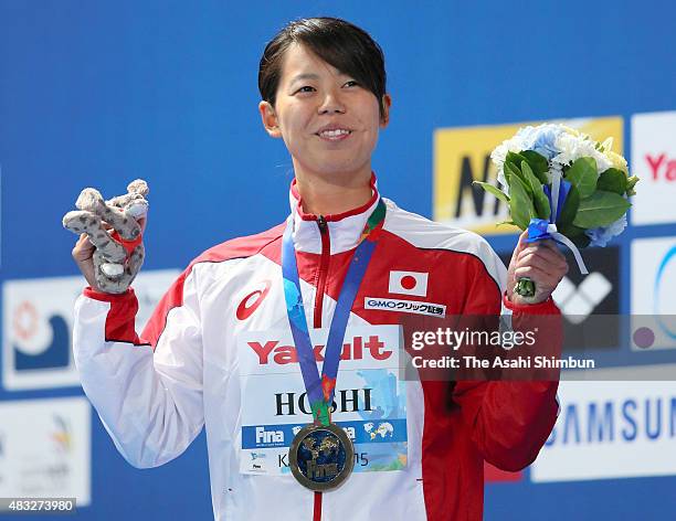 Gold medallist Natsumi Hoshi of Japan celebrates on the podium at the medal ceremony for the Women's 200m Butterfly on day thirteen of the 16th FINA...