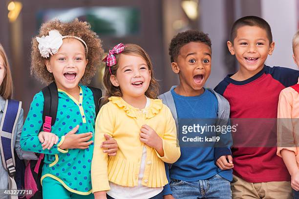 multiracial group of children in preschool hallway - excitement stock pictures, royalty-free photos & images