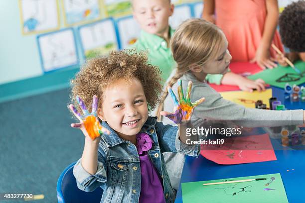 little girl in kindergarten class doing art project - children only stock pictures, royalty-free photos & images