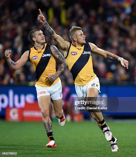 Brandon Ellis of the Tigers celebrates with Dustin Martin of the Tigers after scoring a goal during the round 19 AFL match between the Adelaide Crows...