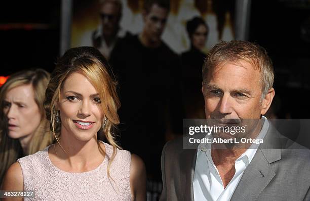 Actor Kevin Costner and wife Christine Baumgartner arrive at the Premiere Of Paramount Pictures' "Jack Ryan: Shadow Recruit" held at TCL Chinese...