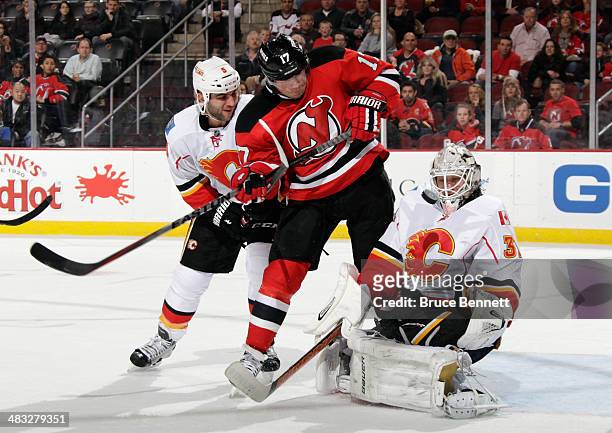 Karri Ramo of the Calgary Flames makes the second period save as Michael Ryder of the New Jersey Devils is checked by Mark Giordano at the Prudential...