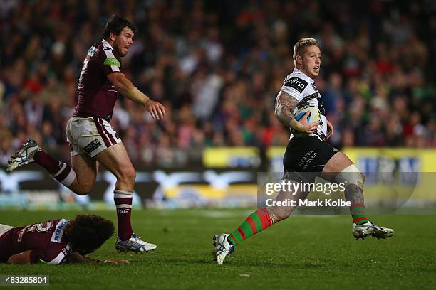 Aaron Gray of the Rabbitohs evades the tackle of Josh Starling and Jorge Taufua of the Eagles during the round 22 NRL match between the Manly Sea...