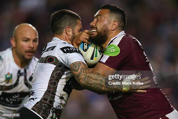 Adam Reynolds of the Rabbitohs tackles Feleti Mateo of the Eagles during the round 22 NRL match between the Manly Sea Eagles and the South Sydney...