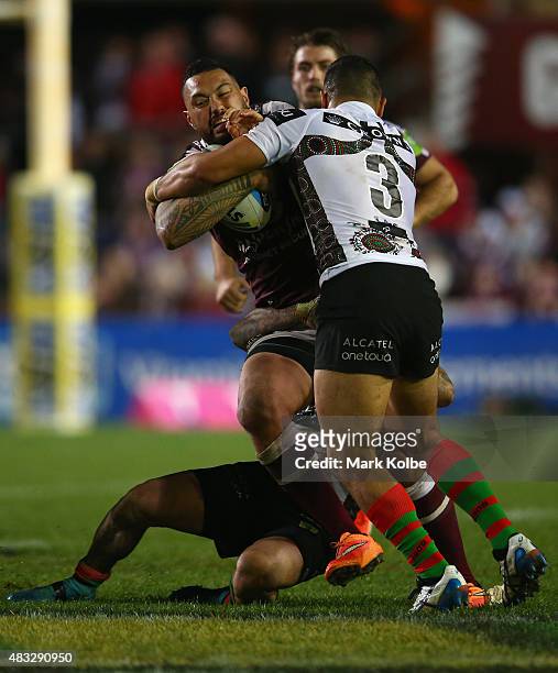 Feleti Mateo of the Eagles is tackled during the round 22 NRL match between the Manly Sea Eagles and the South Sydney Rabbitohs at Brookvale Oval on...